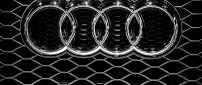 Audi emblem on a grille - Metal logo wallpaper