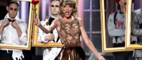 Taylor Swift sings on scene with a red rose in hand