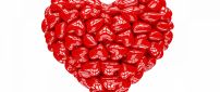 A big 3D heart made of many small red hearts