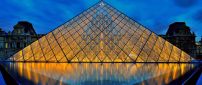 Louvre museum pyramid lighted in night