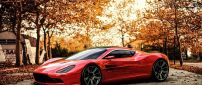 Red Aston Martin in a park in a autumn day