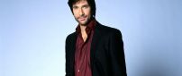 Dylan McDermott in black and red