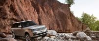 Gray Range Rover on the rocks