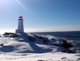 Winter time on the sea - lighthouse in the sun