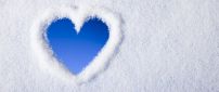 View the blue sky - heart from snow on the window