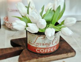 Beautiful white tulips in an old coffee can