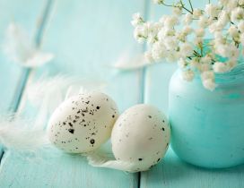 White Easter eggs and a bouquet of flowers