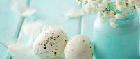 White Easter eggs and a bouquet of flowers