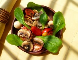 Delicious salad with mushrooms tomatoes and spinach