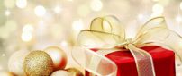Golden ribbon and Christmas ball - Happy Winter Holiday