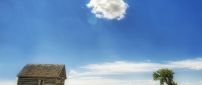 Hot sunshine over the wooden cottage - One fluffy cloud