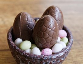 Chocolate Easter eggs in a basket - Happy Spring Holiday