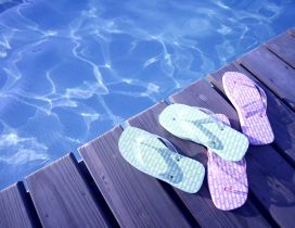 Blue and pink flip flop near the pool - Summer time