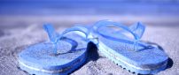 Macro blue flip flop full with beach sand - Summer time