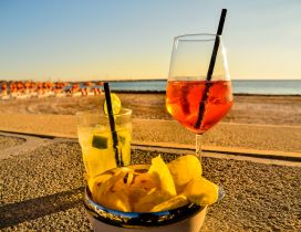 Summer fruits and cocktails on the beach