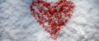 Red heart on the white snow - Happy Valentine's Day