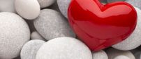Big red heart near grey rocks - Love wins Valentines Day