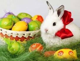 Big red ribbon on a fluffy Easter bunny - Colored eggs