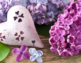 Painted Lilac flowers on a stone in shape of heart