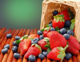 Strawberries and blueberries in a wooden basket
