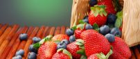 Strawberries and blueberries in a wooden basket