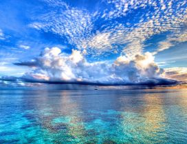 White clouds on the beautiful blue sky - Ocean mirror