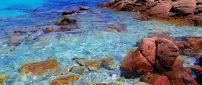 Rusty rocks in the blue ocean water - HD wallpaper