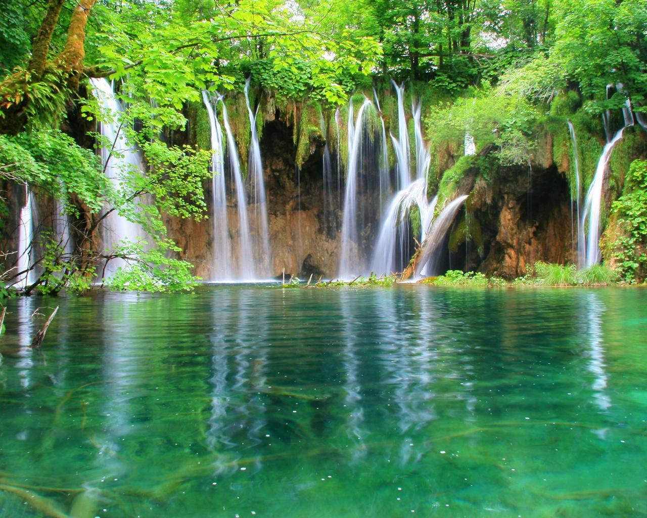 Green nature - beautiful waterfall and mountain lake